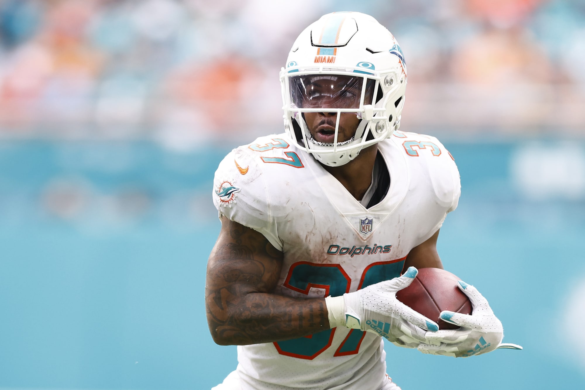 Miami Dolphins running back Salvon Ahmed (26) and running back Myles Gaskin  (37) watch from the sideline during the first half of a NFL preseason  football game Las Vegas Raiders, Saturday, Aug.